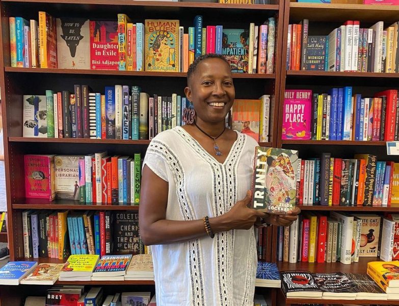 Zelda Lockhart poses with her book at The Regulator Bookshop.