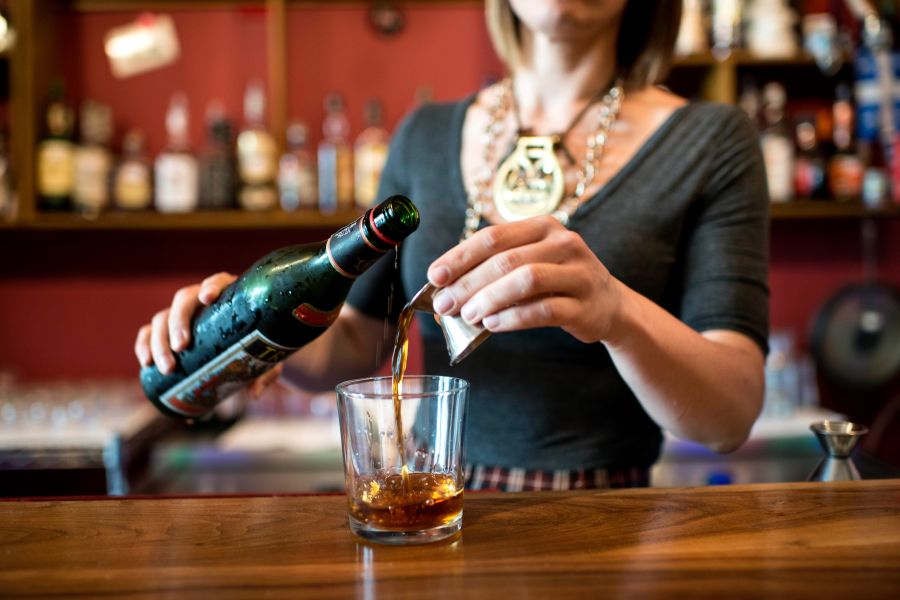 A bartender pours a drink at Bar Virgile in Durham, NC.