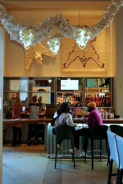A couple at the bar at Counting House Restaurant in 21c Museum Hotel