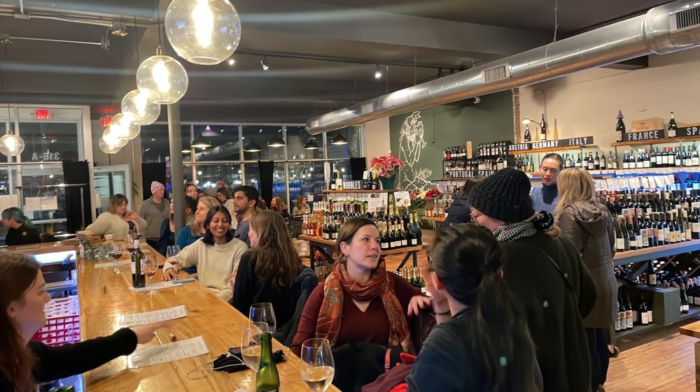 Customers sit at the bar socializing at LouElla in Durham, NC.