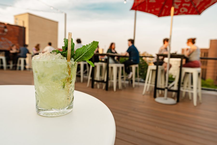Bar-goers sit on the patio at Velvet Hippo enjoying the fresh air.