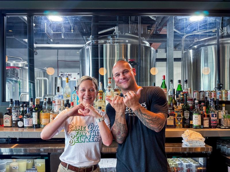 Co-owners Ragen and Andy pose in their brewery and restaurant, Fizzwerks.