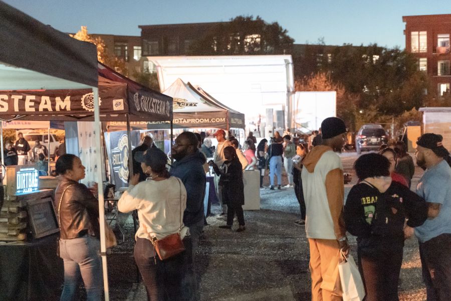 Festival goers visit tents at Blacktoberfest in Durham, NC.