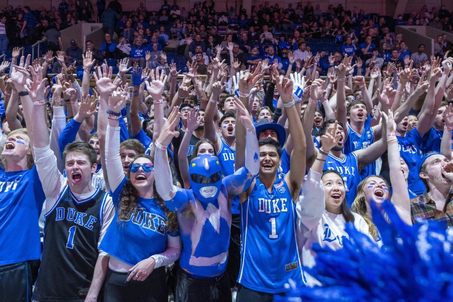 College students in royal blue cheer for Duke at Cameron Indoor Stadium.