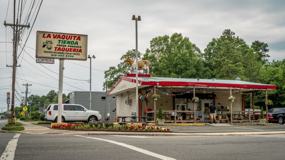 Clouds roll over the storefront of Taqueria La Vaquita in Durham, NC.
