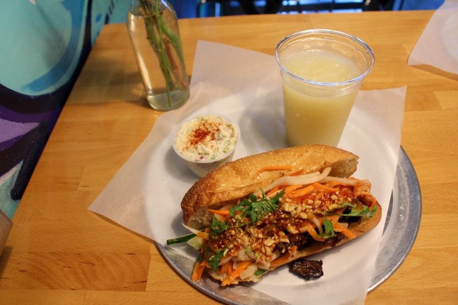 A delicious looking Bahn-mi sits next to a drink at Kokyu Na'Mean in Durham, NC