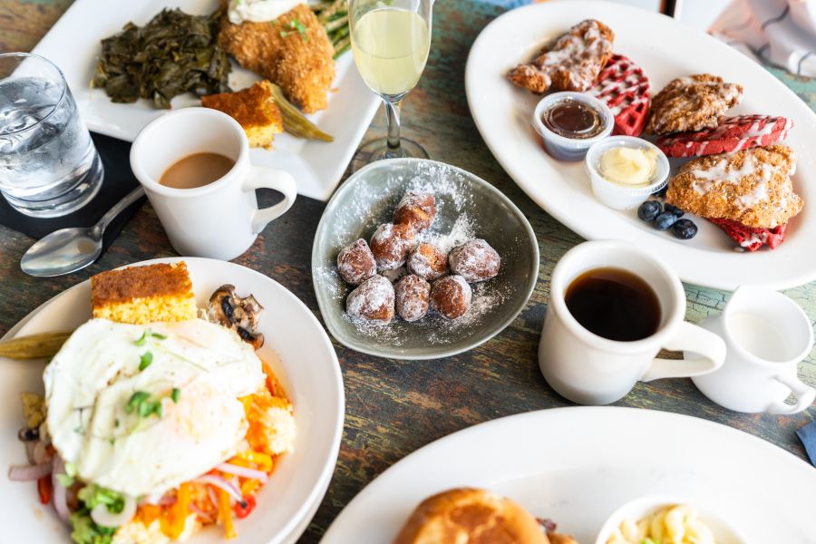 A plate of donut holes is centered around a luxuriously sweet spread of brunch items from Lula & Sadies.