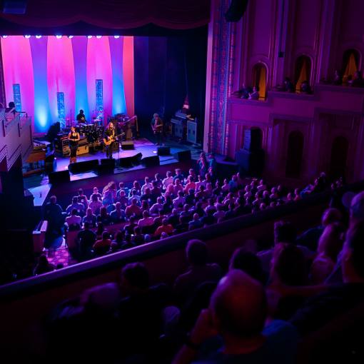 Lights melding between blue and pink bathe the stage of The Carolina Theatre in Durham, NC.