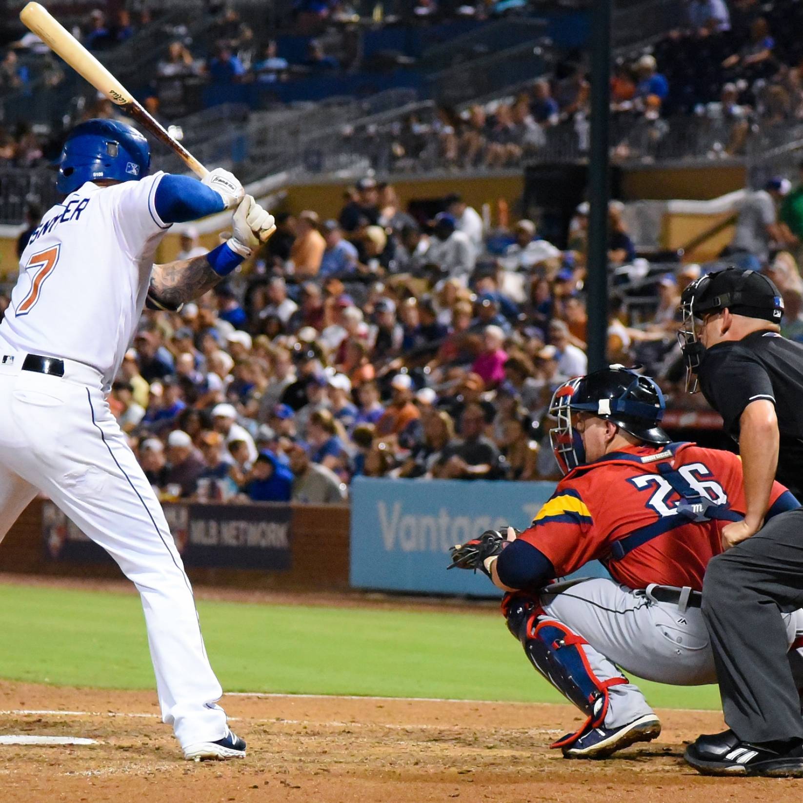 A Durham Bulls player stands poised with his bat at home plate, ready to knock the ball out of the park.
