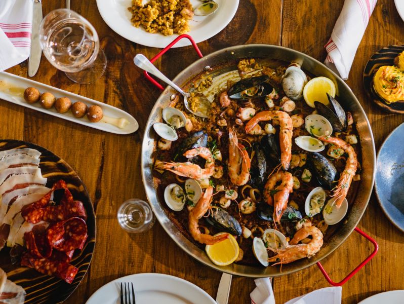 A colorful dish sits in a pan on a table at Mateo.