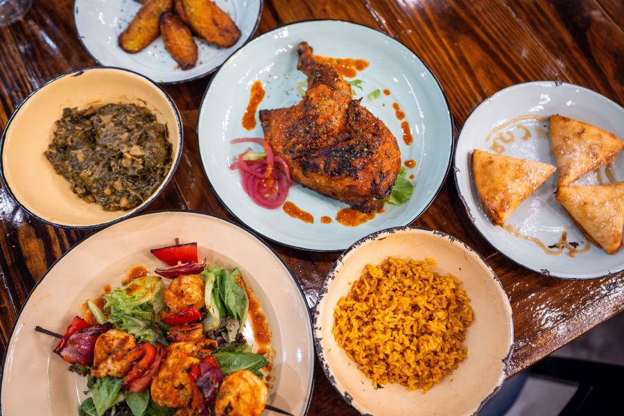 A colorful spread of dishes adorns a table at Zweli's at Brightleaf in Durham, NC.