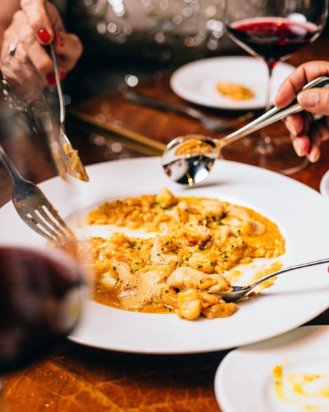 Multiple diners dig into a plate at Nana's in Durham.