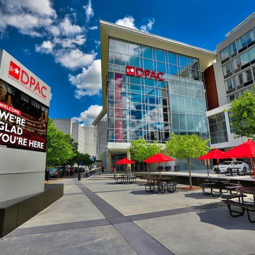 The venue front of Durham Performing Arts Center welcomes viewers on a sunny day.
