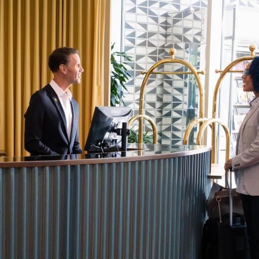 A woman checks in at the front desk of The Durham Hotel.