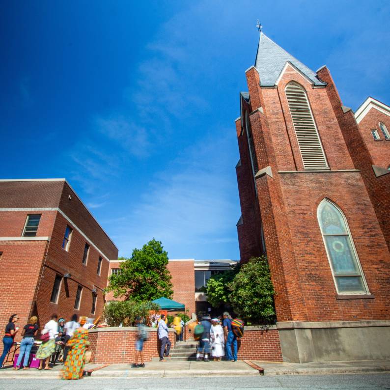 St. Joseph's AME Church stands tall on a sunny day under cloudless skies.