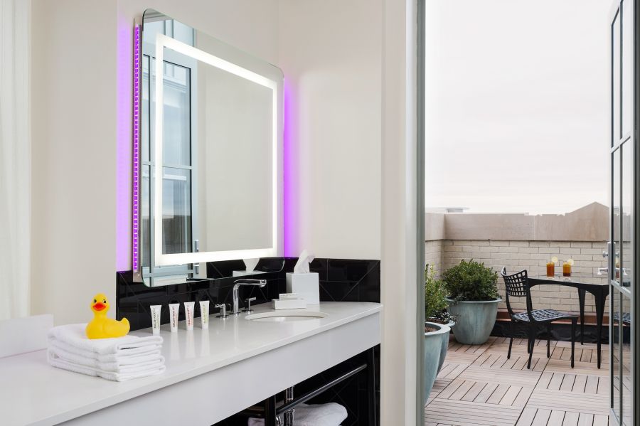 Past the bathroom vanity, the porch invites guests to sit at one of the rooms in Durham's 21c Museum Hotel.