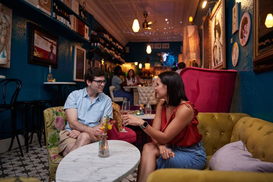A couple enjoys a glass of wine at Killer Queen Wine Bar in Durham, NC.