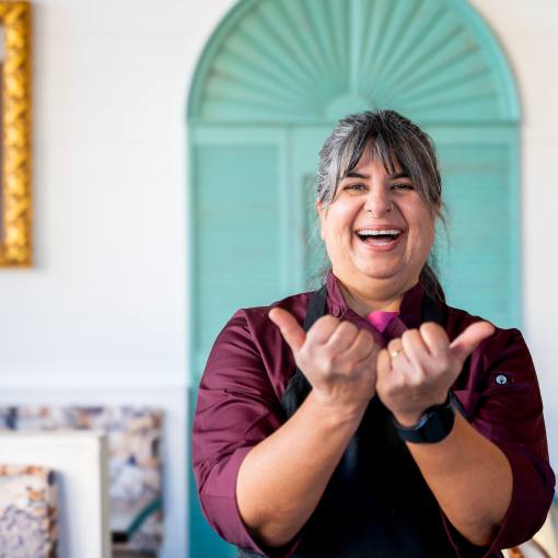 Cheeni owner Preeti Waas holds up her hands in the bull horns sign in support of the Love Durham campaign