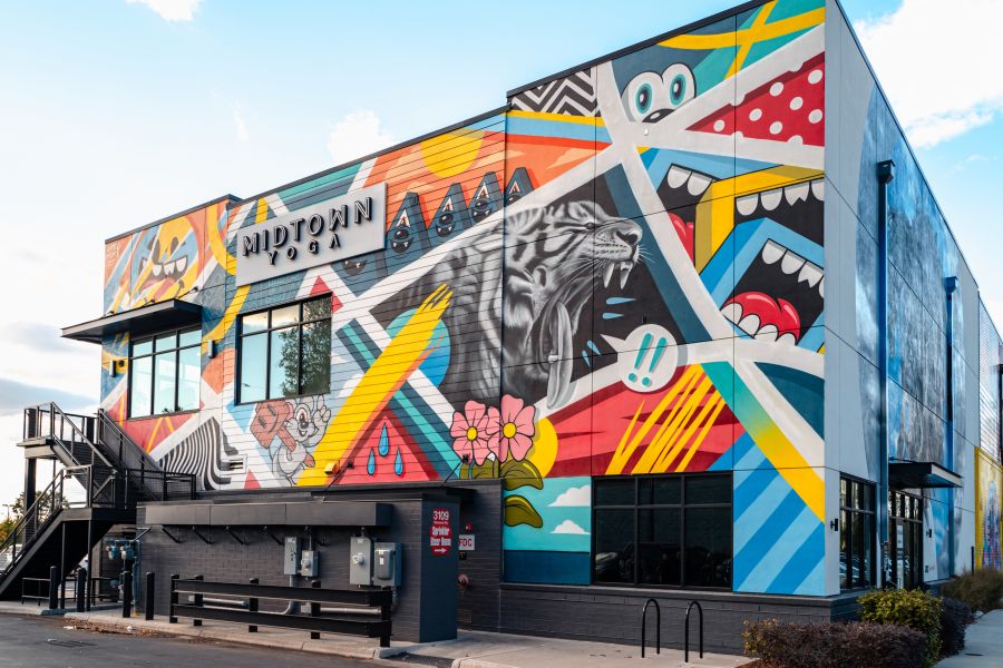 The walls of Midtown Yoga are vibrantly colored with a complex mural at UHill Walls.