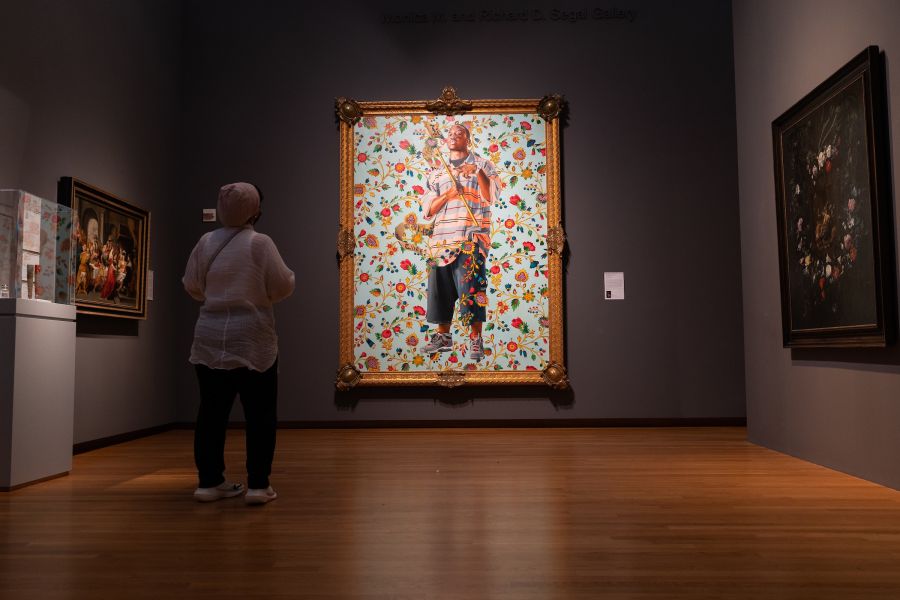 A guest views St. John the Baptist II, by Kehinde Wiley at The Nasher Museum of Art.