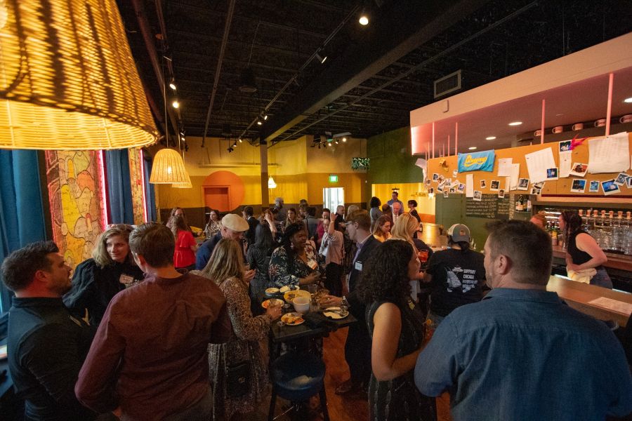 Customers gather around at Queeny's restaurant during an event.