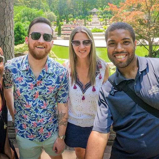 A group of friends smile for a photo in Durham, NC