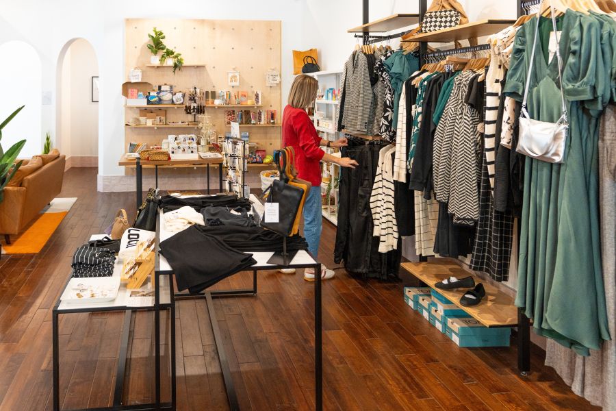 A shopper picks through the colorful racks of clothing at Rose & Lee in Durham, NC.